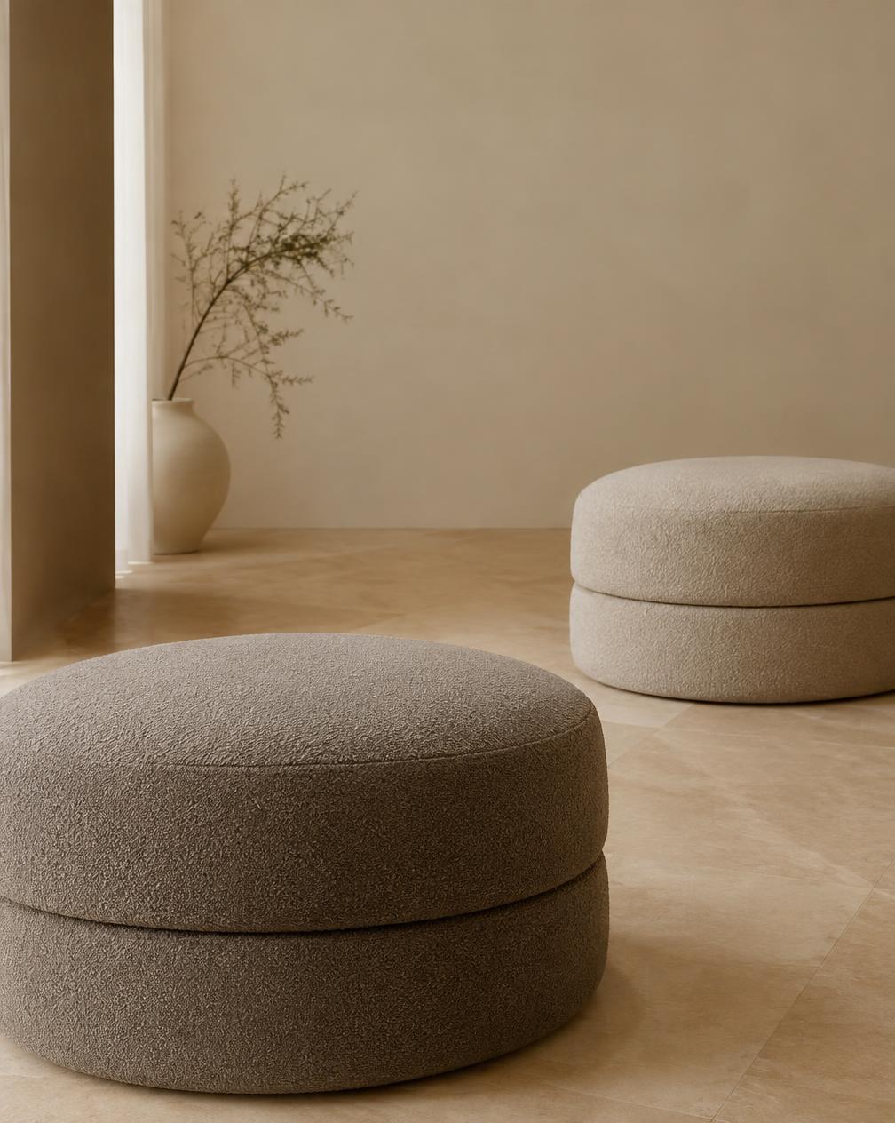 Round bouclé ottomans in taupe and sand